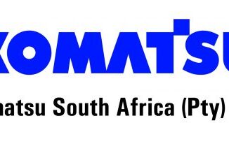 Komatsu South Africa Artisan Assistant III working on heavy earthmoving machinery in a workshop environment